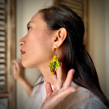 Load image into Gallery viewer, Woman wearing a yellow and green patterned earring, with a blurred background.