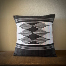 Load image into Gallery viewer, Decorative pillow with geometric pattern on a wooden surface and beige wall background