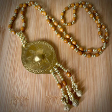 Load image into Gallery viewer, Filipino heritage necklace featuring a gold-tone pendant inspired by the Kulintang gong ensemble.