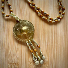Load image into Gallery viewer, Filipino heritage necklace featuring a gold-tone pendant inspired by the Kulintang gong ensemble.