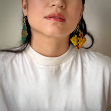 Load image into Gallery viewer, Close-up of a person wearing colorful earrings with a neutral background
