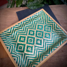 Load image into Gallery viewer, Woven tray with green and white pattern on a wooden surface
