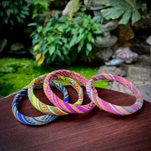 Load image into Gallery viewer, Colorful braided bracelets on a wooden surface with a natural background
